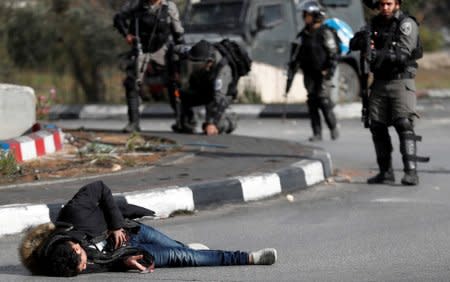 Israeli border policemen stand away after shooting a Palestinian man with a knife and what looks like an explosive belt near the Jewish settlement of Beit El, near the West Bank city of Ramallah. December 15, 2017. REUTERS/Goran Tomasevic/File photo