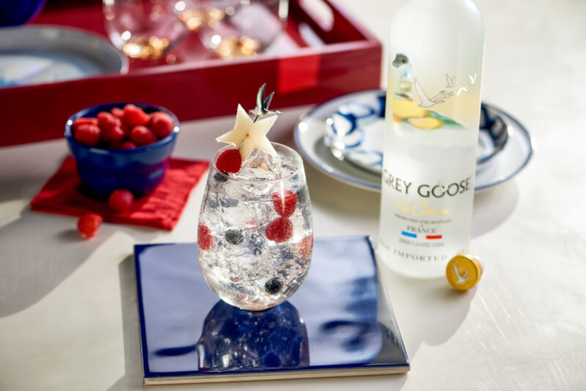 <p>Grey Goose</p><p>What's red, white and blue and tastes like 4th of July spirit? This American flag in a glass, that's what.</p><p>Recipe Courtesy of <a href="https://www.greygoose.com/" rel="nofollow noopener" target="_blank" data-ylk="slk:Grey Goose;elm:context_link;itc:0;sec:content-canvas" class="link rapid-noclick-resp">Grey Goose</a>:</p><p>• 1.5 oz Grey Goose Le Citron </p><p>• .5 oz Bacardi Pineapple </p><p>• Soda water </p><p>• Raspberries and blueberries for garnish </p>