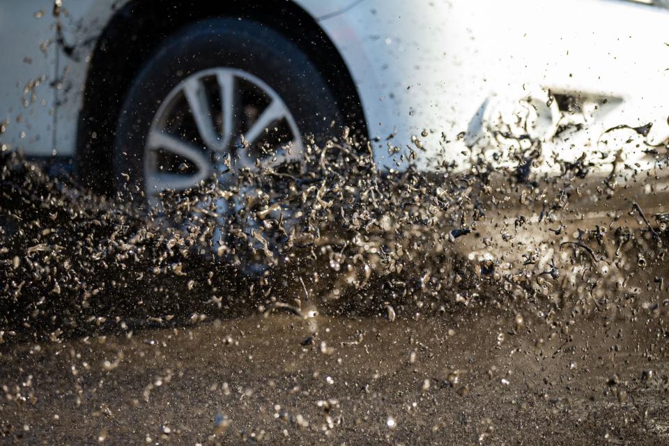 A car drives through several inches of sludge that covers that ground in Steinhatchee, Fla. in the hours after Hurricane Idalia tore through the Big Bend on Wednesday, Aug. 30, 2023.