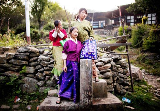 Bhutanese school girls stand by a water tap on their way home from school in a village near the town of Haa in October last year. The 31-year-old king of Bhutan, an Oxford-educated bachelor crowned in the remote Himalayan country in 2008, set up another royal wedding on Friday by announcing his engagement