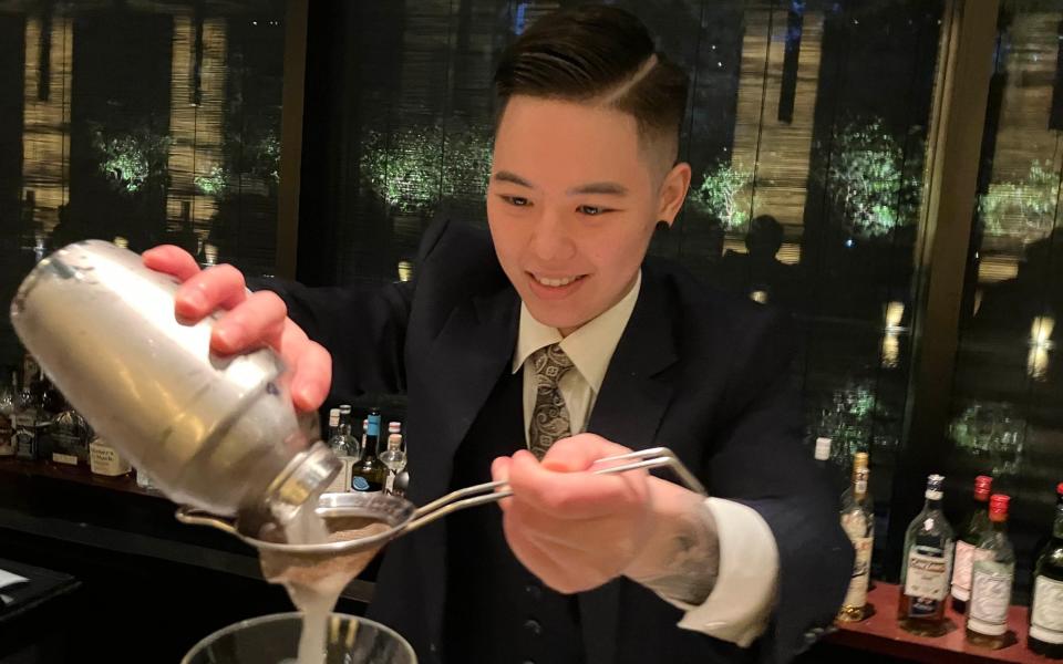 A mixologist crafting a fresh cocktail at a hotel on the Bund - Marcel Theroux