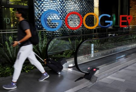 A man passes a Google signage outside their office in Singapore