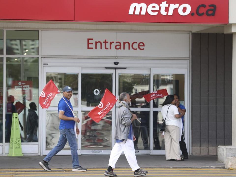  Striking Metro Inc. grocery store workers holding picket lines in Toronto.