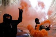 Protesters hold smoke flares during a rally against the laws to provide separatist-held regions with a special status near the Ukrainian parliament in Kiev, September 17, 2014. REUTERS/Valentyn Ogirenko