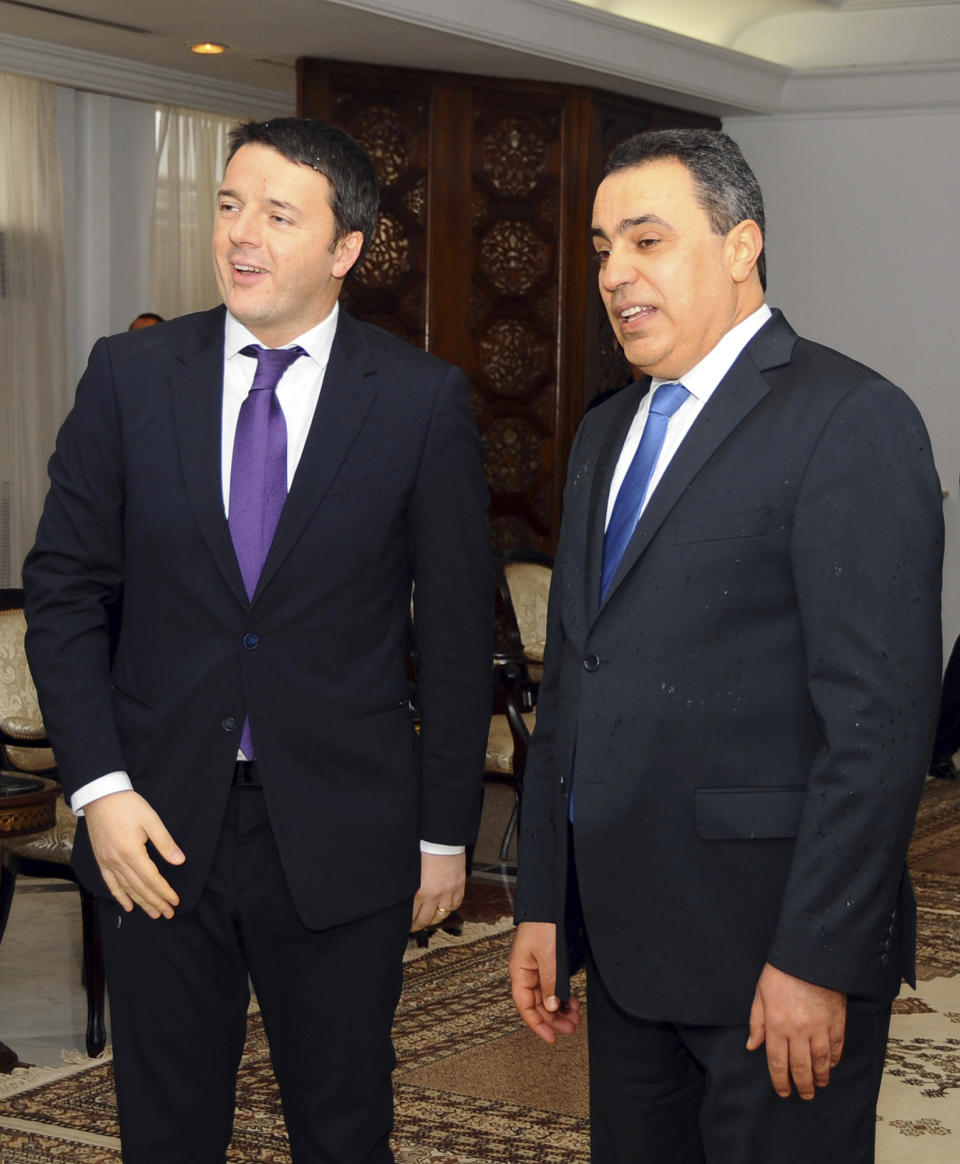 Tunisian Prime Minister, Mehdi Jomaa, 2nd right, greets his Italian counterpart, Matteo Renzi , upon his arrival at Tunis airport, Tunisia, Tuesday, March 4, 2014. Renzi is in Tunisia for a one-day official visit. (AP Photo/Hassene Dridi)