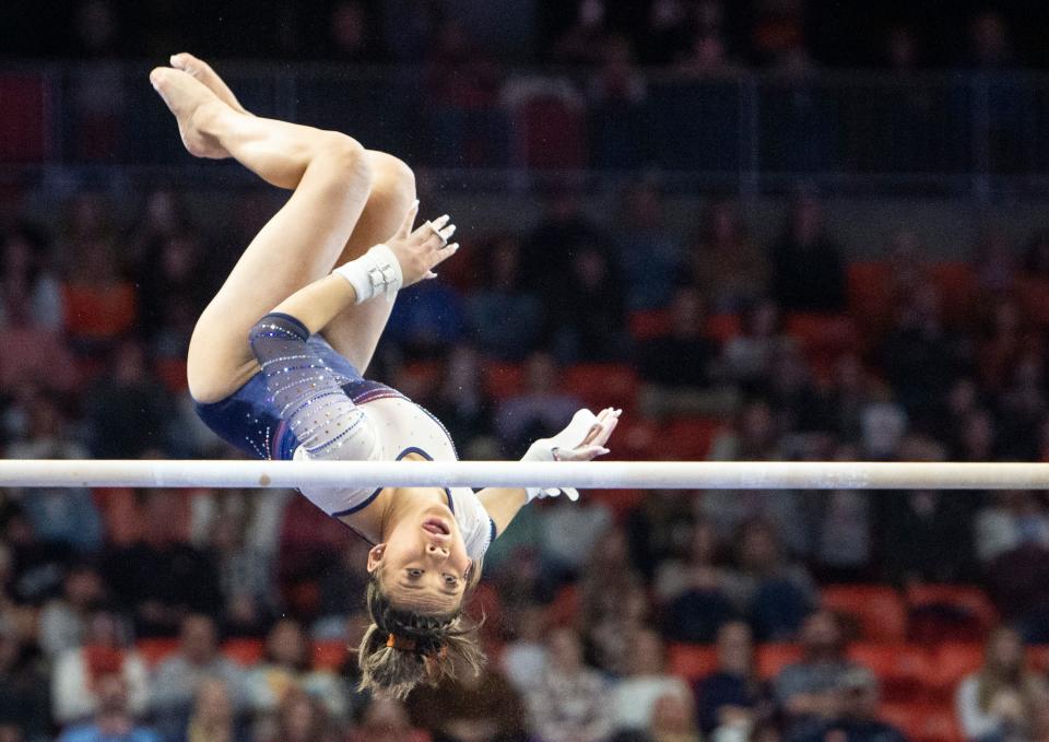 Suni Lee dismounts from the bars as Auburn gymnastics takes on Missouri at Auburn Arena.