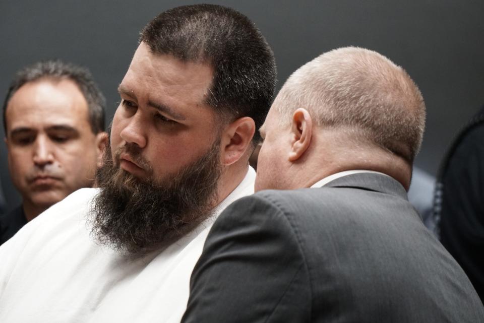 Deric "Tuna" McGuire listens to his attorney during arraignment in May 2018.