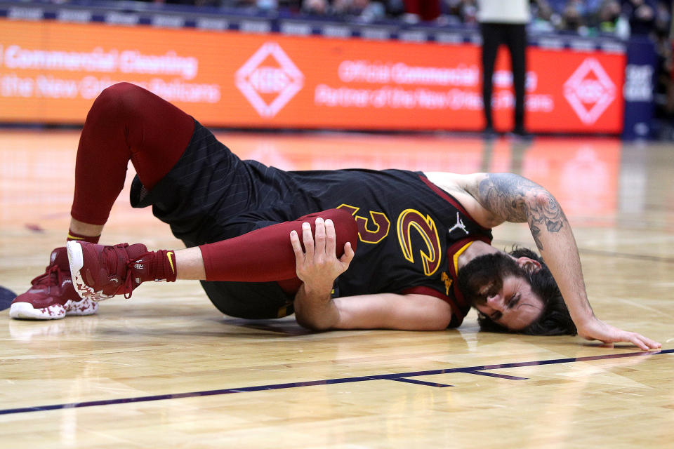 NEW ORLEANS, LOUISIANA - DECEMBER 28: Ricky Rubio #3 of the Cleveland Cavaliers holds his left knee after sustaining an injury during the fourth quarter of a NBA game against the New Orleans Pelicans at Smoothie King Center on December 28, 2021 in New Orleans, Louisiana. The New Orleans Pelicans won the game 108 - 104. NOTE TO USER: User expressly acknowledges and agrees that, by downloading and or using this photograph, User is consenting to the terms and conditions of the Getty Images License Agreement. (Photo by Sean Gardner/Getty Images)