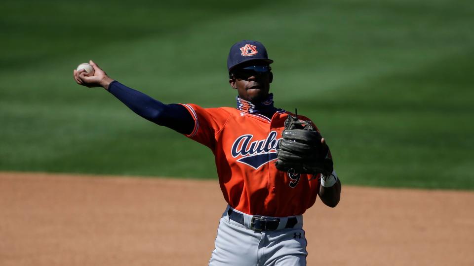 Auburn Ryan Bliss (9) throws to first during an NCAA baseball game against Mississippi on Sunday, March 21, 2021 in Oxford, MS.  (AP Photo/Butch Dill)