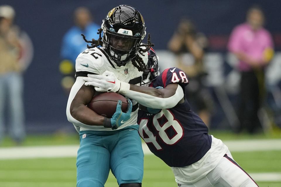 Jacksonville Jaguars running back JaMycal Hasty (22) is hit by Houston Texans linebacker Christian Harris (48) on a run during the first half of an NFL football game in Houston, Sunday, Jan. 1, 2023. (AP Photo/David J. Phillip)