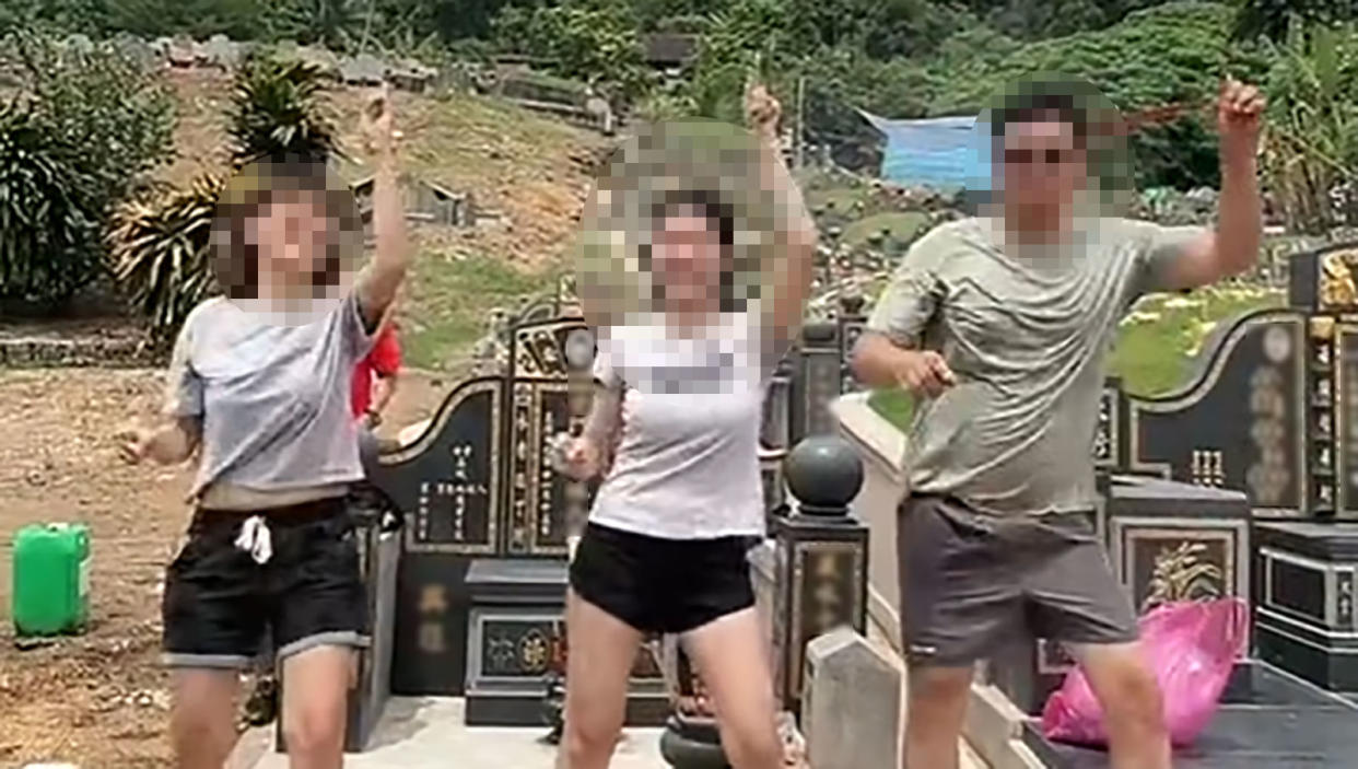 A viral video on Facebook with the title 'Young people doing tomb sweeping', showcased three individuals dressed in t-shirts and shorts dancing in front of several tombstones. (Screenshot: Ryan Choo via Facebook)