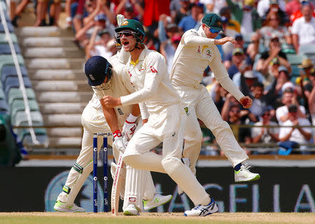 Cricket - Australia v England - Ashes test match - WACA Ground, Perth, Australia, December 17, 2017 - Australia's captain Steve Smith celebrates with team mates after taking a catch to dismiss England's captain Joe Root during the fourth day of the third Ashes cricket test match. REUTERS/David Gray