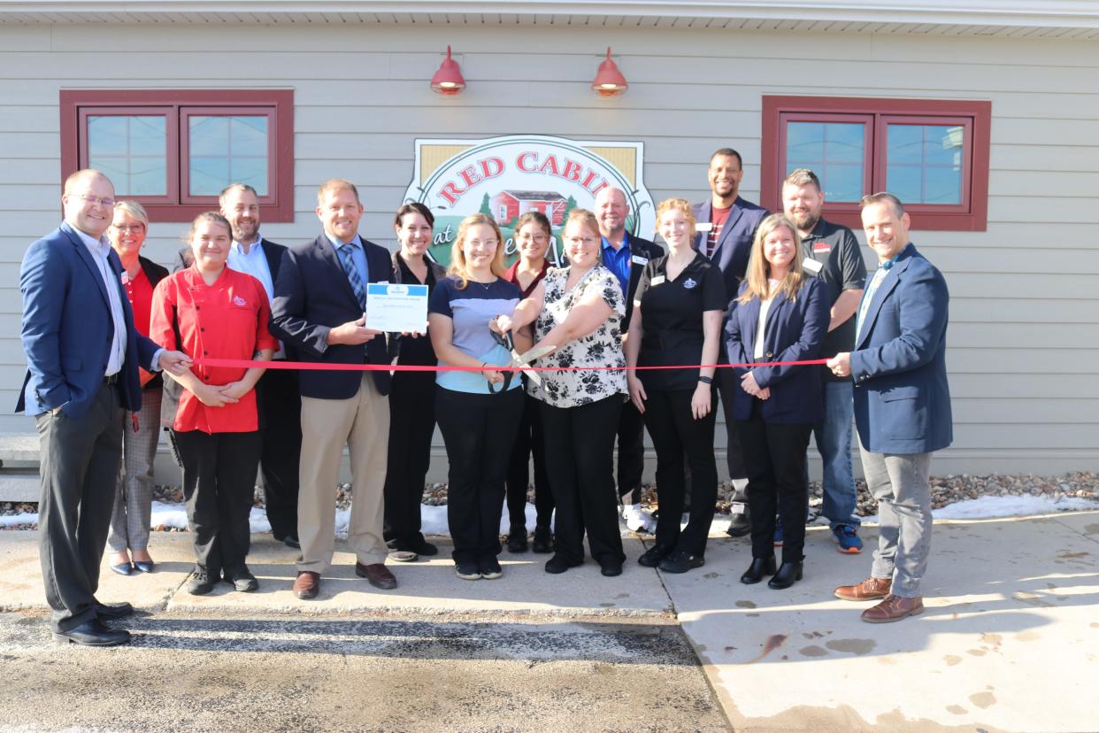 Envision Greater Fond du Lac celebrated new ownership of Red Cabin at Green Acres with a ribbon cutting. Hailey Rohlfs and Sara Michaelson, center with scissors, said they will continue with traditions the restaurant is known for, and introduce new items. It is located at W2701 4th Street Road. For more information, visit https:// www. redcabingreenacres.com.