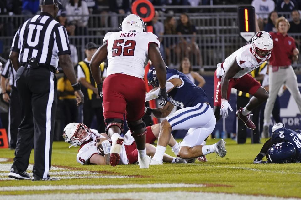 North Carolina State quarterback Brennan Armstrong (5) scores a touchdown in the first quarter of an NCAA college football game UConn in East Hartford, Conn., Thursday, Aug. 31, 2023. (AP Photo/Bryan Woolston)