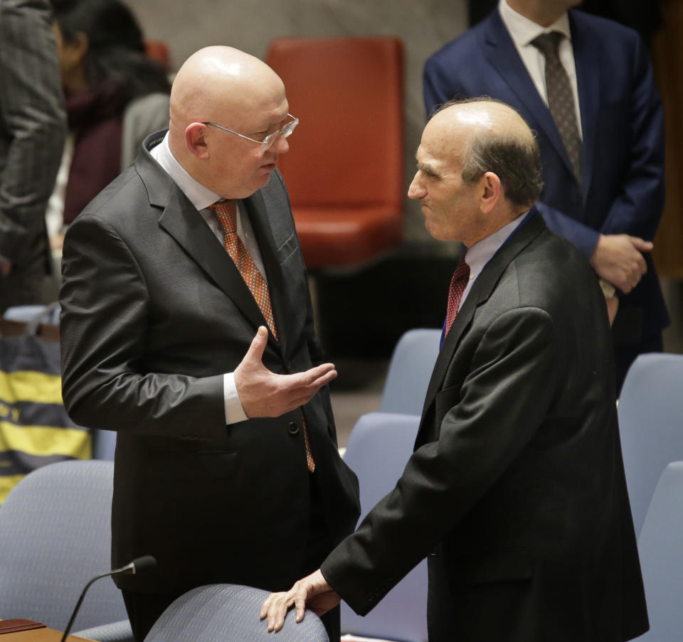 Russian ambassador to the United Nations Vasily Nebenzya, left, speaks to the United States special envoy to Venezuela Elliott Abrams before the start of a Security Council meeting at U.N. headquarters, Thursday, Feb. 28, 2019. (AP Photo/Seth Wenig)