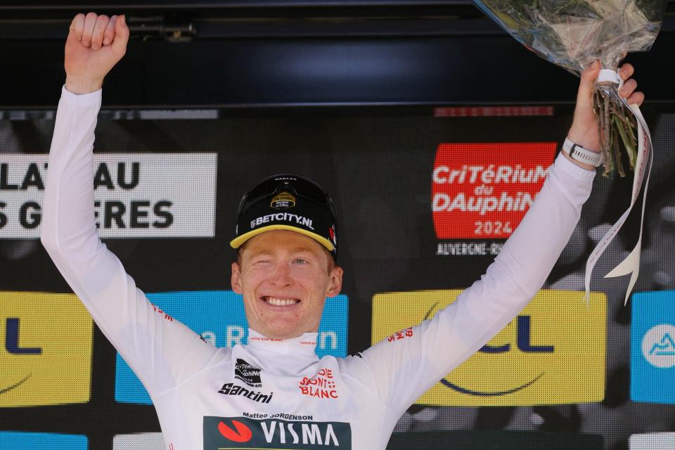 Team Visma's US rider Matteo Jorgenson celebrates with the best young rider's white jersey on the podium after the eighth and last stage of the 76th edition of the Criterium du Dauphine cycling race near Thorens-Glieres, French Alps, on June 9, 2024.