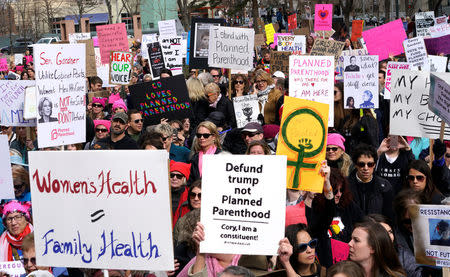 Planned Parenthood supporters hold signs at a protest in downtown Denver February 11, 2017. REUTERS/Rick Wilking