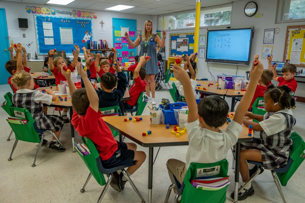 Holy Spirit Catholic School teacher Kristy Demetres works with her first grade students on number facts Monday. The school is one of two in Florida that was recognized by the United States Department of Education as a 2022 National Blue Ribbon School.