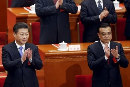 China's President Xi Jinping (L) and Premier Li Keqiang clap during the closing session of the National People's Congress (NPC) at the Great Hall of the People in Beijing, China, March 16, 2016. REUTERS/Kim Kyung-hoon