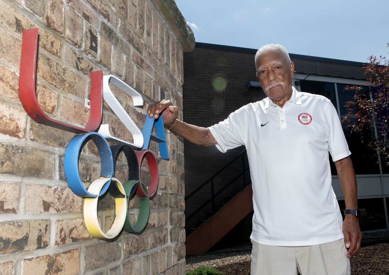 Lester Carney, 90, of Akron, who won a silver medal at the 1960 Rome Olympics in the 200 meters, poses with the Glenn "Jeep" Davis statue next to Barberton Public Library. Carney and Davis were friends who both competed in the 1960 Summer Games.