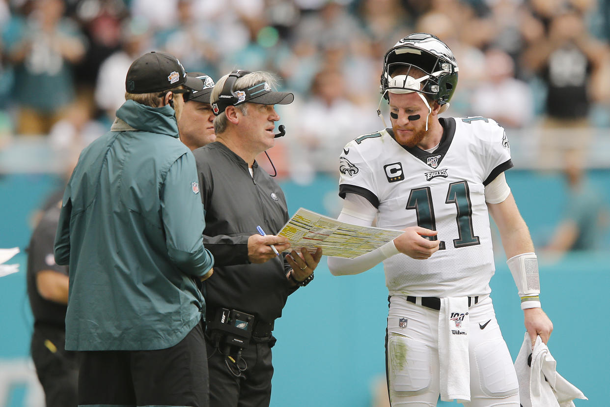 MIAMI, FLORIDA - DECEMBER 01:  Carson Wentz #11 of the Philadelphia Eagles talks with head coach Doug Pederson against the Miami Dolphins during the second quarter at Hard Rock Stadium on December 01, 2019 in Miami, Florida. (Photo by Michael Reaves/Getty Images)