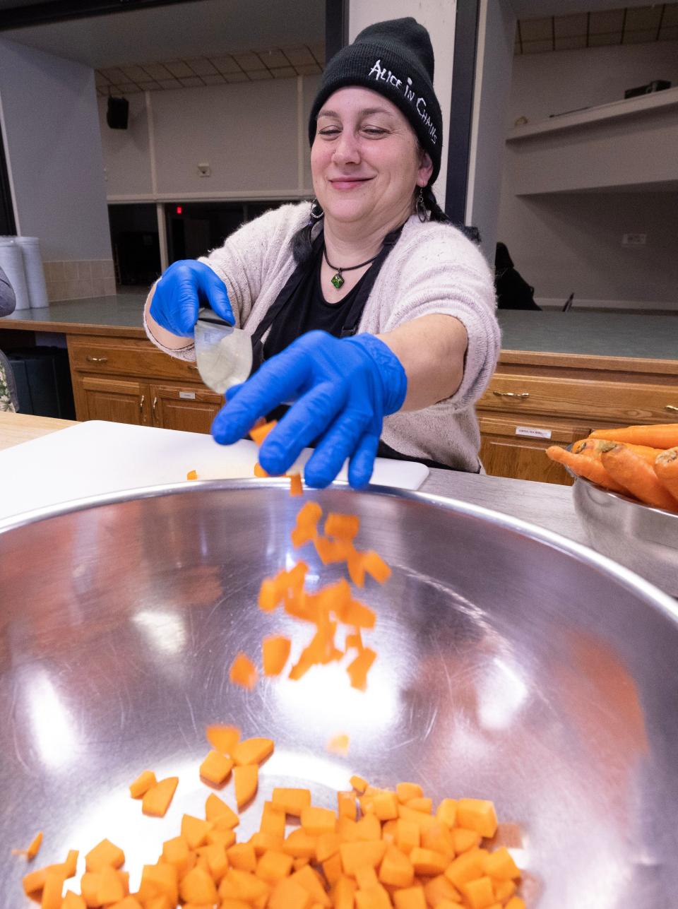 Volunteer Monica Bowe of Canton adds ingredients to a chicken corn chowder soup as Compassion Delivered prepares its delivery meals at Evermore Community Church in Lake Township.