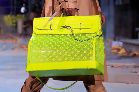 A model presents a bag creation by designer Virgil Abloh during a preview show for his Fall/Winter 2019-2020 collection for fashion house Louis Vuitton during Men's Fashion Week in Paris, France, January 17, 2019. REUTERS/Gonzalo Fuentes