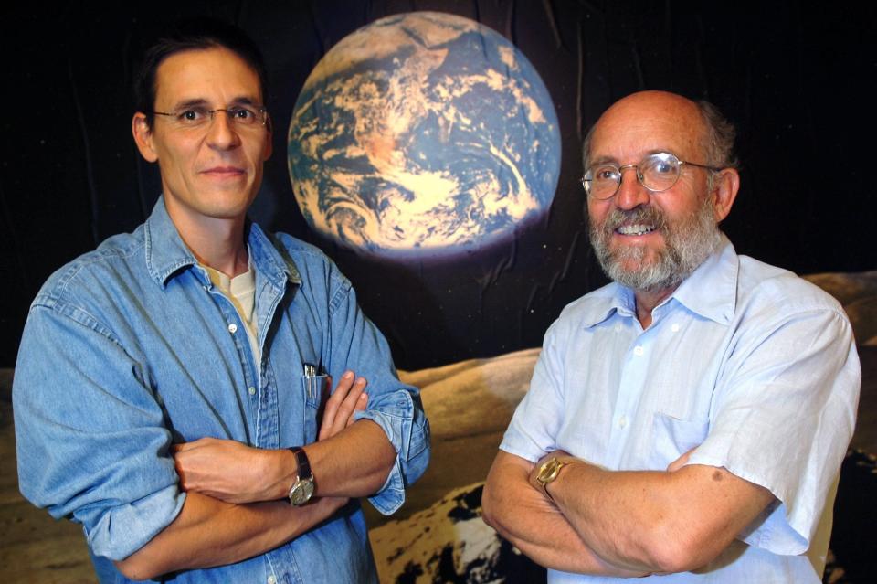 FILE - In this Thursday, Aug. 11, 2005 file photo Swiss Astronomers Michel Mayor, right, and Didier Queloz, left, pose for the photographer at the Astronomical Observatory of the University of Geneva. The 2019 Nobel prize in Physics was given to James Peebles "for theoretical discoveries in physical cosmology," and the other half jointly to Michel Mayor and Didier Queloz "for the discovery of an exoplanet orbiting a solar-type star," said Prof. Goran Hansson, secretary-general of the Royal Swedish Academy of Sciences that chooses the laureates. (Laurent Gillieron, Keystone via AP)