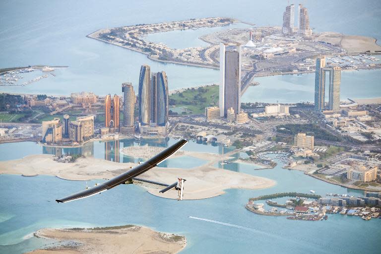 The solar-powered plane Solar Impulse 2 flies over the Emirati capital Abu Dhabi on February 26, 2015