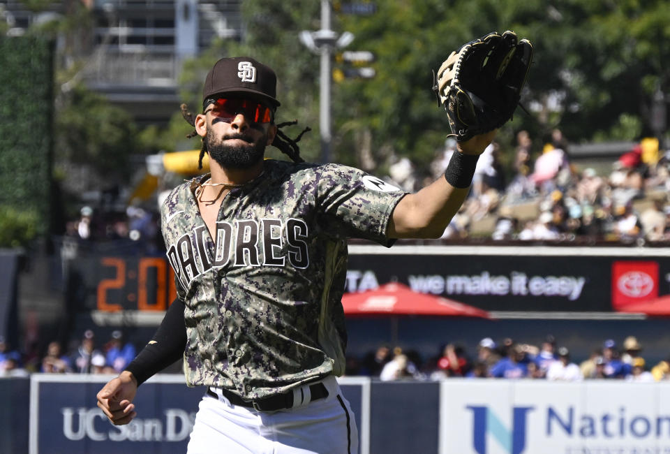 San Diego Padres right fielder Fernando Tatis Jr. acknowledges fans after making a leaping catch to take away a home run from St. Louis Cardinals' Michael Siani during the sixth inning of a baseball game, Sunday, Sept. 24, 2023, in San Diego. (AP Photo/Denis Poroy)