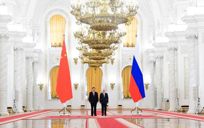 Russian president Vladimir Putin meets with China's president Xi Jinping at the Kremlin in Moscow - AFP