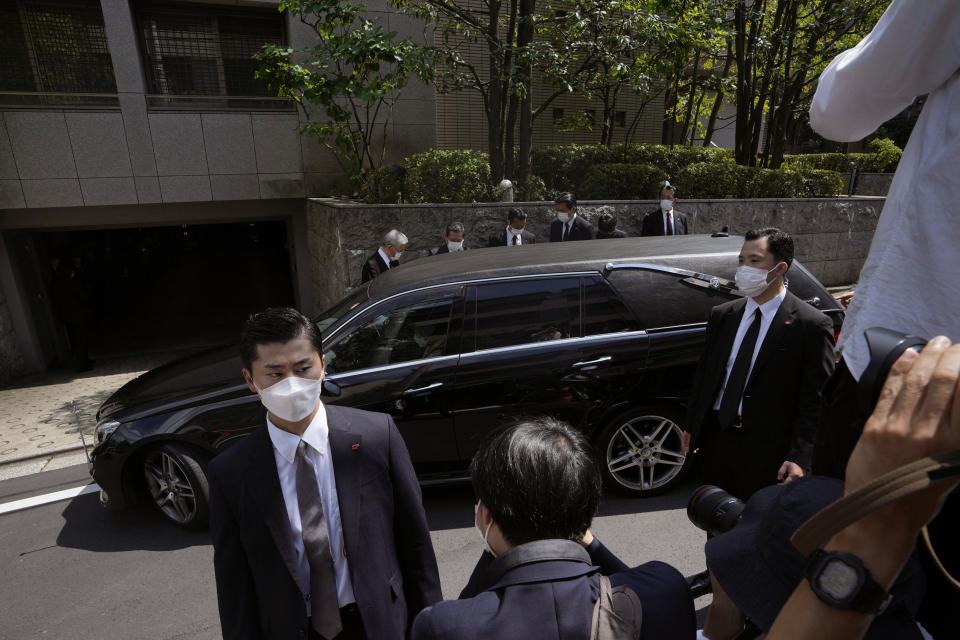 The vehicle which is believed to carry the body of the former Prime Minister Shinzo Abe arrives at his home in Tokyo, Saturday, July 9, 2022. Abe was shot Friday while delivering his speech to support the Liberal Democratic Party's candidate during an election campaign in Nara, western Japan. (AP Photo/Hiro Komae)