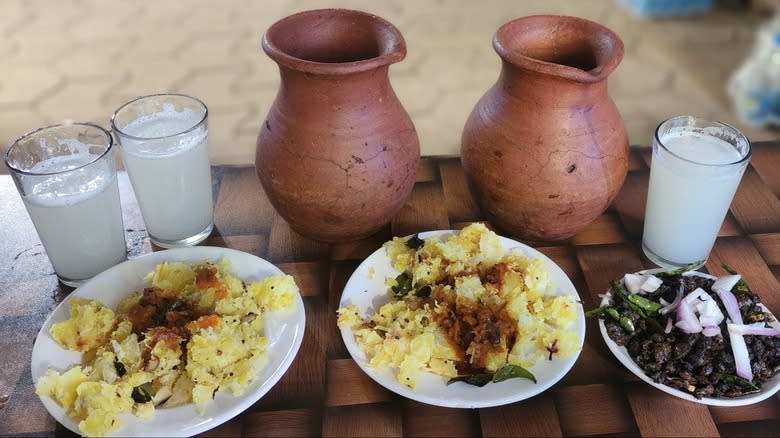 Glasses of palm wine toddy alongside food