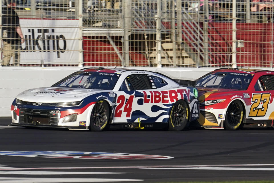 NASCAR Cup Series driver William Byron (24) leads Bubba Wallace (23) down the front stretch in the final laps of the NASCAR Cup Series auto race at Atlanta Motor Speedway in Hampton, Ga., Sunday, March 20, 2022. Williams won the race. (AP Photo/John Bazemore)