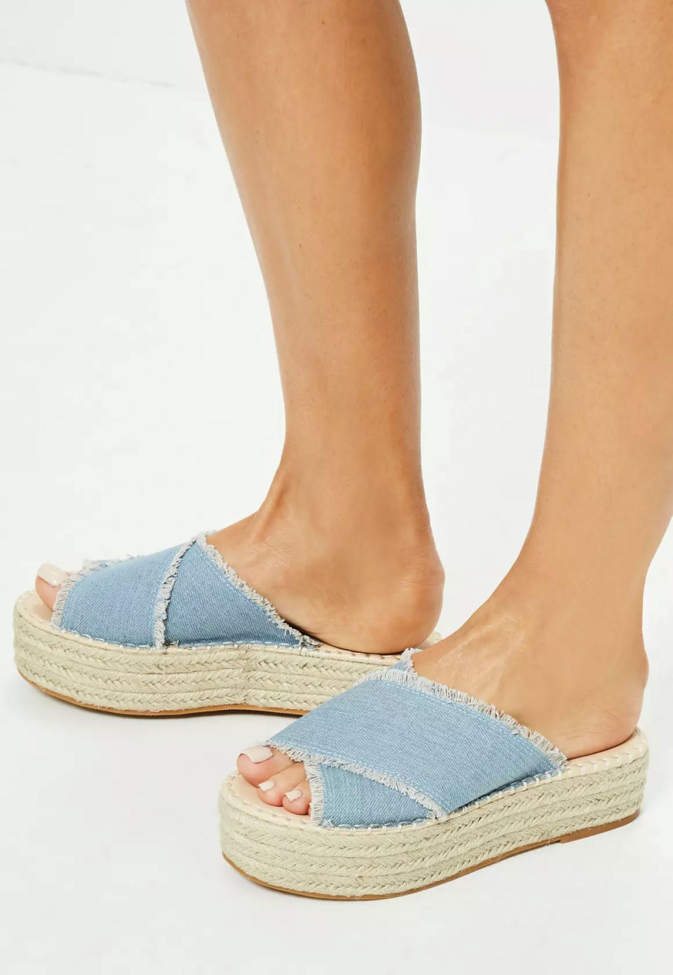 <p>Blue denim cross strap flatform mules, £25, <a rel="nofollow noopener" href="https://www.missguided.co.uk/blue-denim-cross-strap-flatform-mules" target="_blank" data-ylk="slk:Missguided;elm:context_link;itc:0;sec:content-canvas" class="link ">Missguided</a></p>