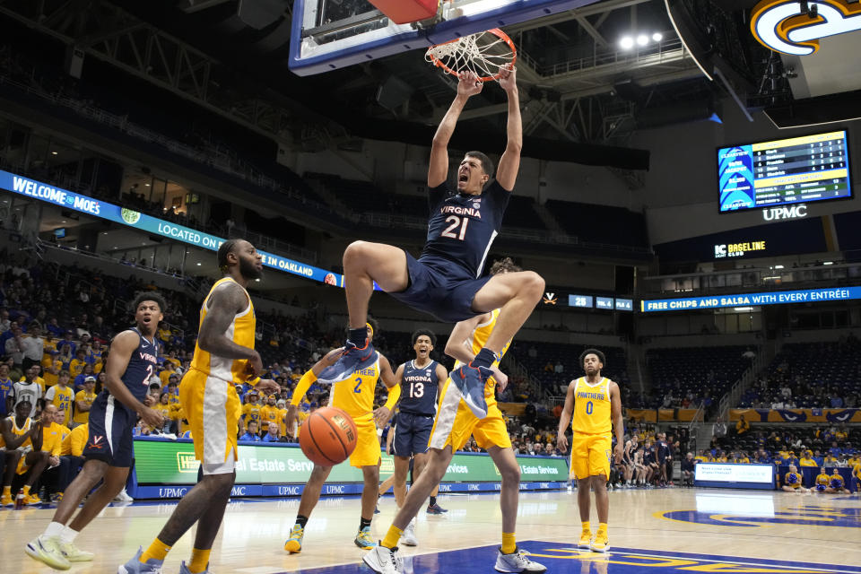 Virginia forward Kadin Shedrick (21) dunks the ball during the first half of an NCAA college basketball game against Pittsburgh in Pittsburgh, Tuesday, Jan. 3, 2023. (AP Photo/Gene J. Puskar)