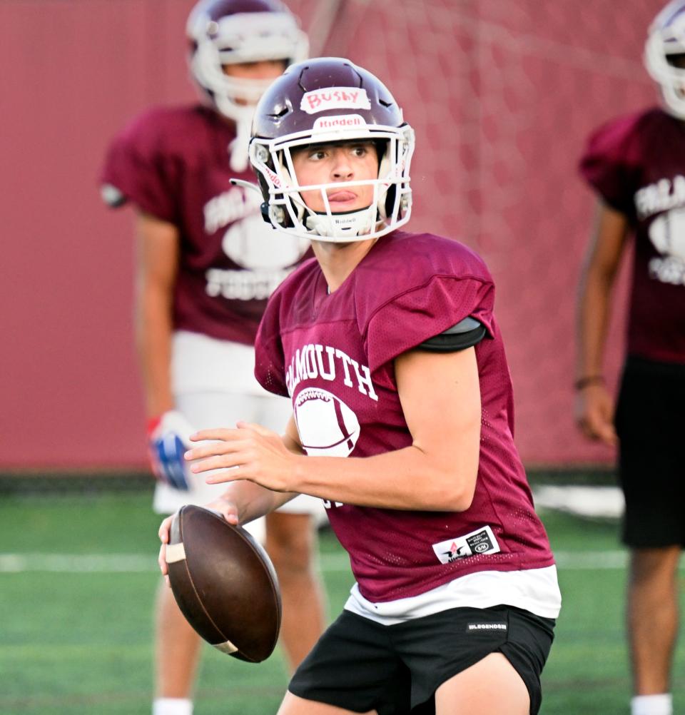 Falmouth quarterback Tommy Bushy looks for a receiver.