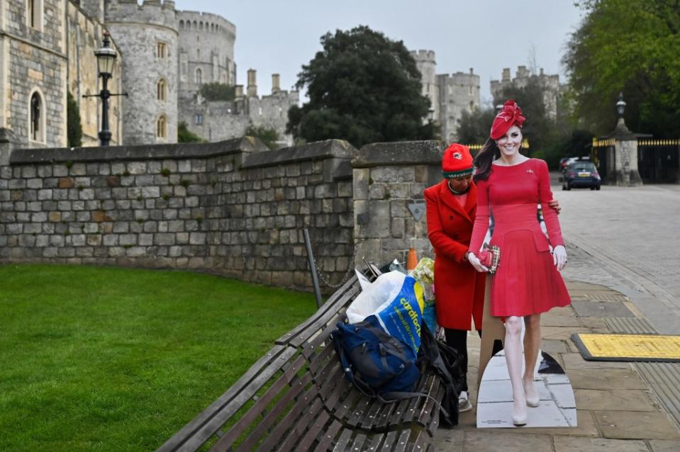 Cardboard cutouts of Kate Middleton and King Charles III in front of Windsor Castle, preparing for the Easter Mattins Service. AFP via Getty Images