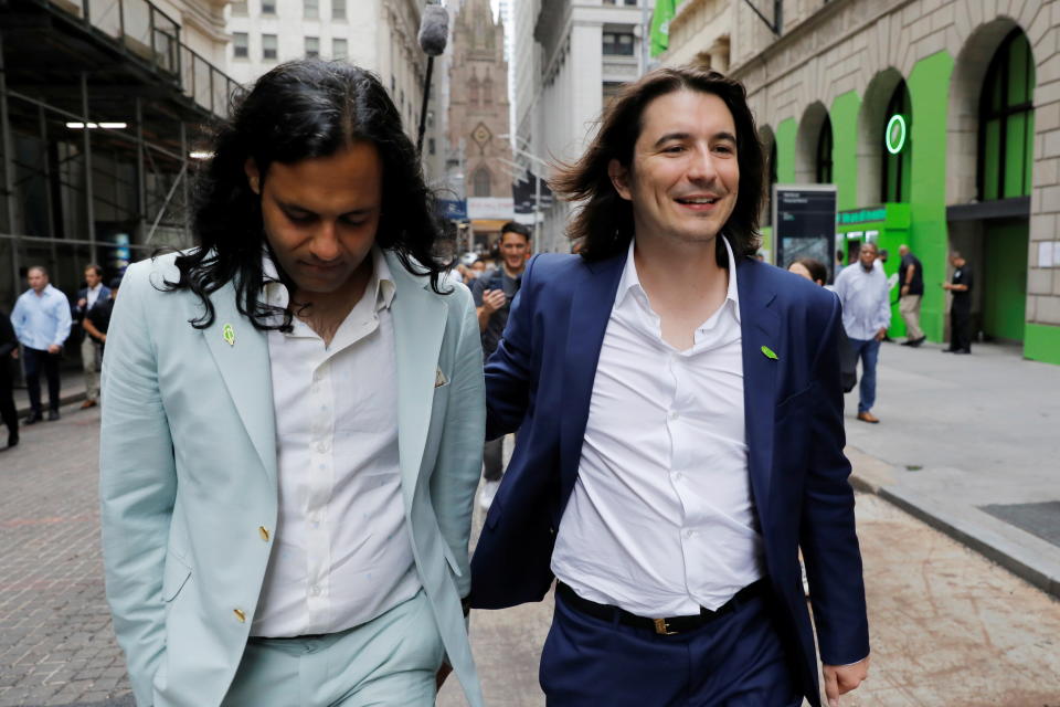 Robinhood Markets, Inc. co-founder Baiju Bhatt and CEO and co-founder Vlad Tenev walk on Wall Street after the company's IPO in New York City, U.S., July 29, 2021.  REUTERS/Andrew Kelly