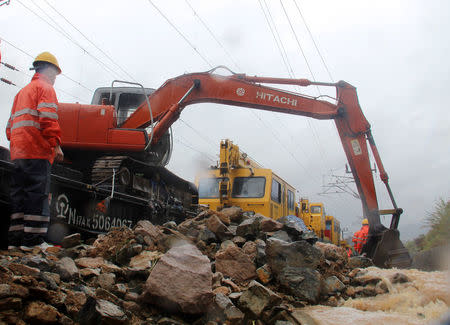 Rescue workers try to recover a railway line affected by Typhoon Megi, in Fuzhou, Fujian province, China, September 28, 2016. REUTERS/Stringer