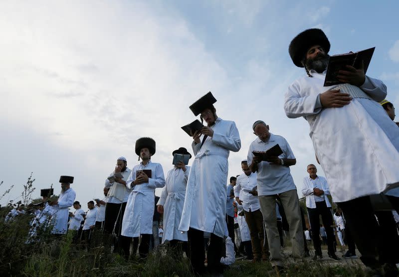 FILE PHOTO: Ultra-Orthodox Jewish pilgrims pray on a bank of a lake near the tomb of Rabbi Nachman of Breslov during the celebration of Rosh Hashanah holiday, the Jewish New Year, in Uman