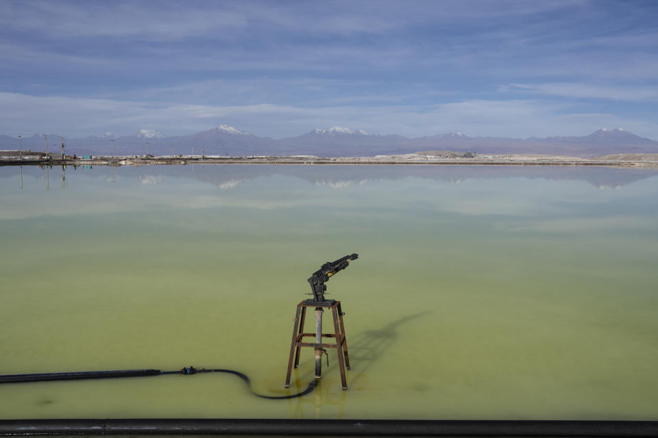 Brine evaporates from pools at the lithium extraction plant facilities of the SQM Lithium company near Peine, Chile, Tuesday, April 18, 2023. In 2016, an investigation found SQM extracted more groundwater than legally permitted for consecutive years, something authorities said “put the stability of the ecosystem in extreme risk.” SQM later accused its neighbor of doing the same. (AP Photo/Rodrigo Abd)