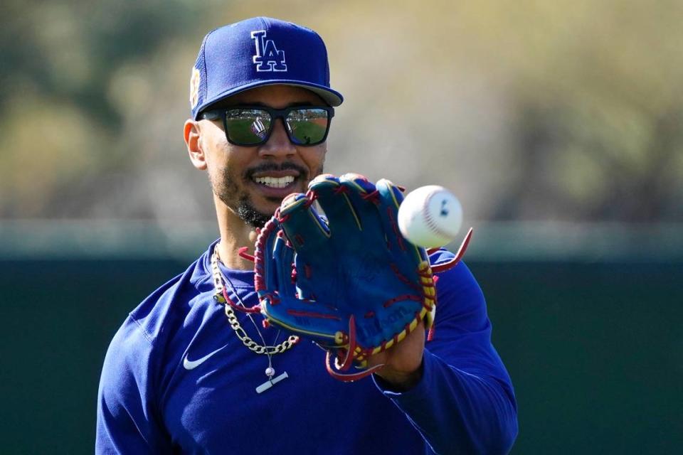 Los Angeles Dodgers’ Mookie Betts reaches to catch a baseball while warming up during spring training baseball workouts for Dodgers players in Phoenix, Monday, Feb. 20, 2023. (AP Photo/Ross D. Franklin)
