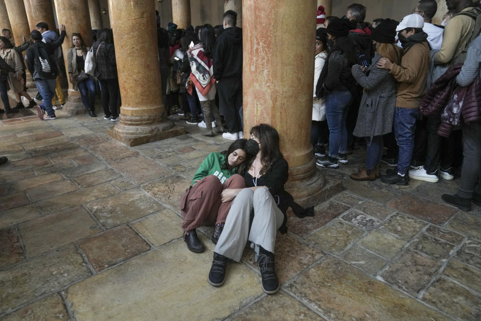 People visits the Church of the Nativity, traditionally believed to be the birthplace of Jesus Christ, in the West Bank town of Bethlehem, Saturday , Dec. 24, 2022. (AP Photo/Mahmoud Illean)