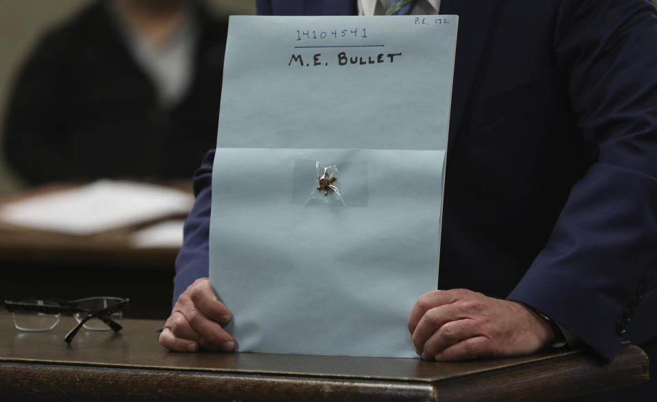 Prosecuting attorney John Maher displays evidence of a used bullet during closing statements in Shomari Legghette's murder trial at the Leighton Criminal Courthouse, Friday, March 13, 2020, in Chicago. Legghette is on trial for first-degree murder in the Feb. 13, 2018, killing of Chicago Police Cmdr. Paul Bauer. (Antonio Perez/Chicago Tribune via AP)