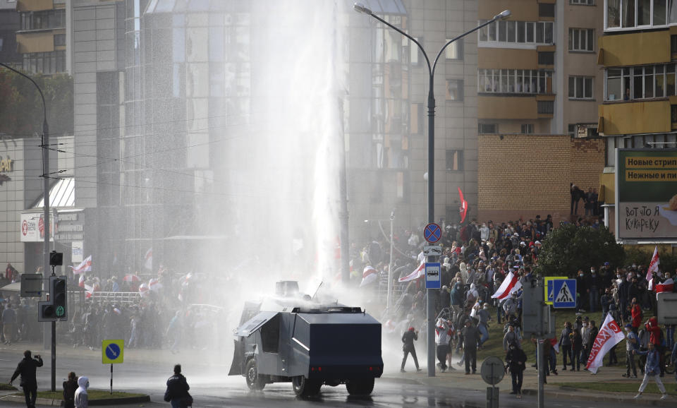 Police use a water cannon toward demonstrators during a rally in Minsk, Belarus, Sunday, Oct. 4, 2020. Hundreds of thousands of Belarusians have been protesting daily since the Aug. 9 presidential election. (AP Photo)