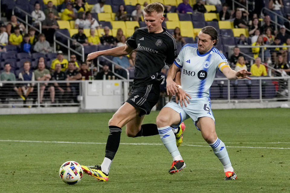 Nashville SC forward Sam Surridge, left, scores a goal past CF Montréal midfielder Samuel Piette (6) during the second half of an MLS soccer match Saturday, May 4, 2024, in Nashville, Tenn. Nashville won 4-1. (AP Photo/George Walker IV)