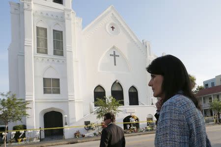 South Carolina Governor Nikki Haley (R) walks between television interviews outside the Emanuel African Methodist Episcopal Church in Charleston, South Carolina, June 19, 2015, two days after a mass shooting left nine dead during a bible study at the church. REUTERS/Brian Snyder