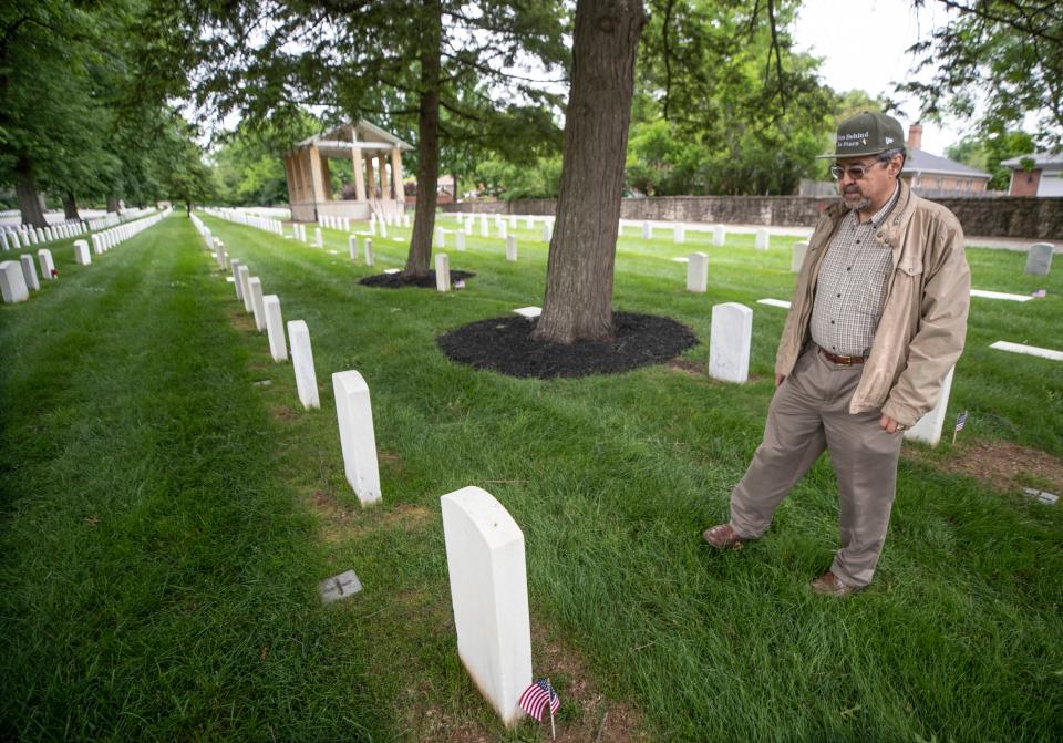 Don Milne has created an app which will document every U.S. service man and woman in WWII. He is seen at the grave side of William Blaine, a veteran who he had done researched at Zachary Taylor National Cemetery in Louisville. May 23, 2022