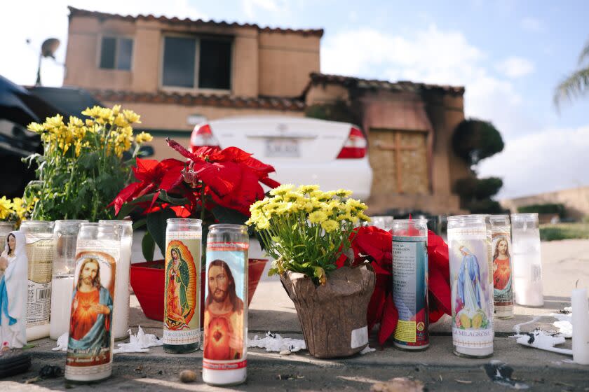 Riverside, CA - November 28: A memorial is seen outside a home where the deaths of three people were found Friday in a burning home at a residence on Monday, Nov. 28, 2022 in Riverside, CA. They are thought to be connected to the attempted abduction of a teenage girl. (Dania Maxwell / Los Angeles Times)